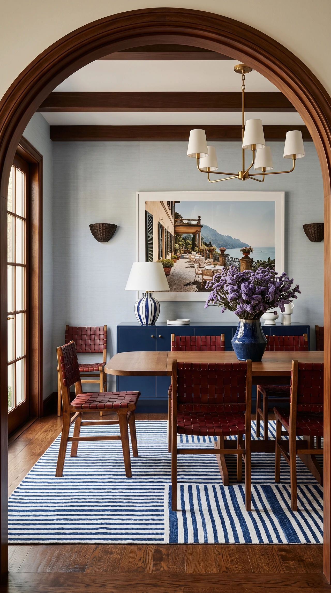 AI-generated dining room framed by a timber arch, with blue cabinetry, red chairs, and a striped rug.