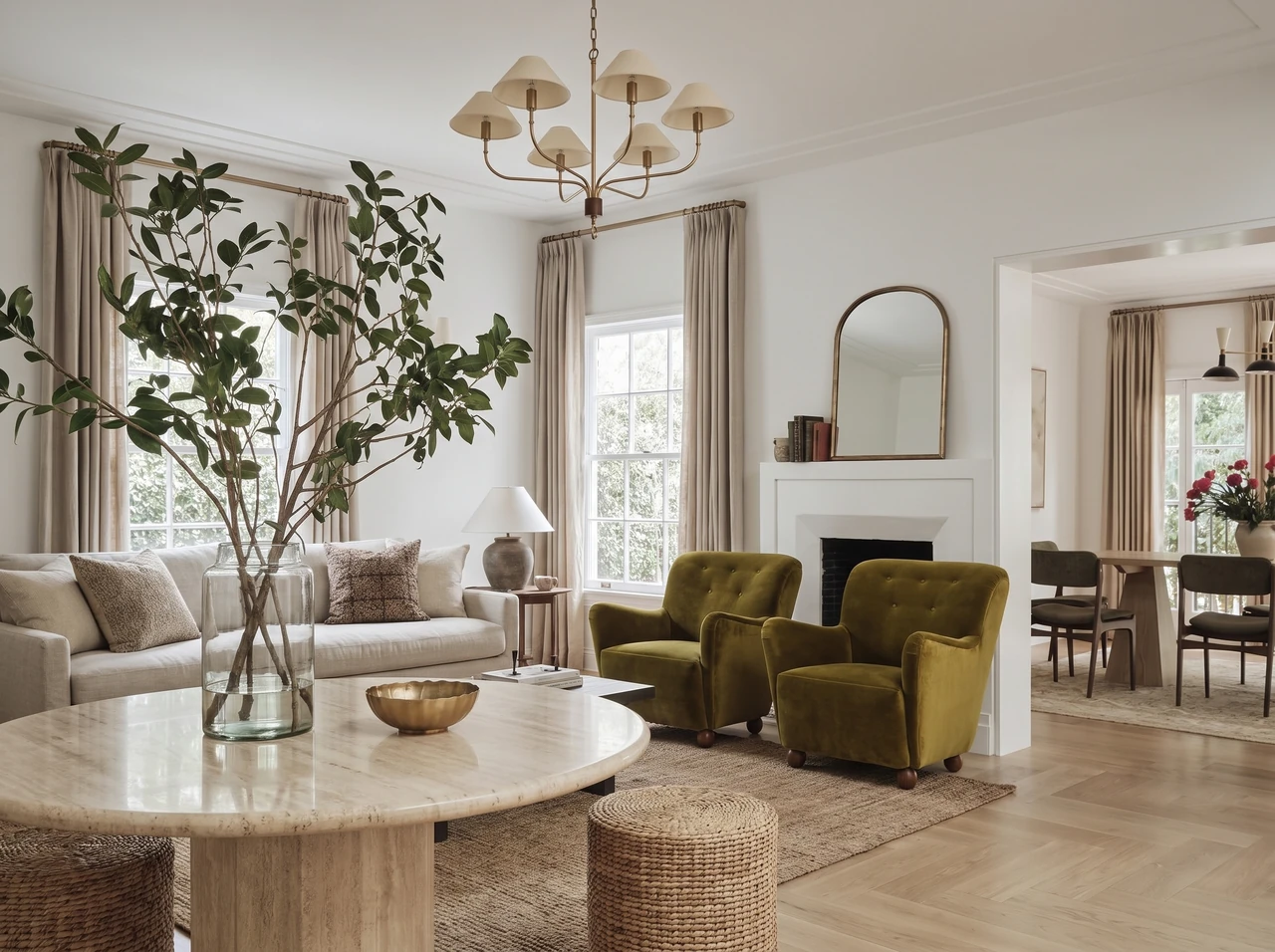 AI-generated light living room with olive armchairs, a pale round coffee table, and leafy branches.