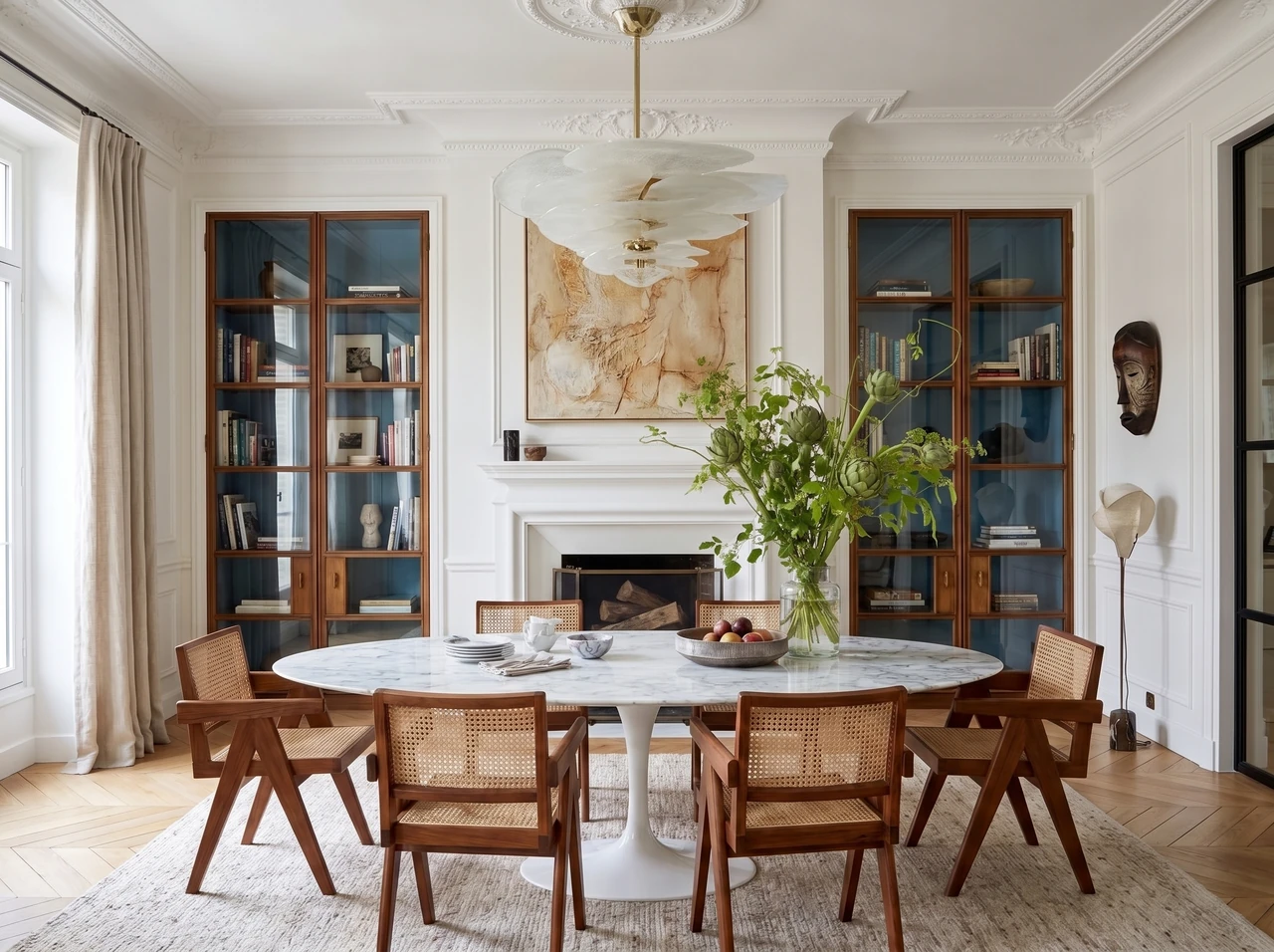 AI-generated dining room with blue-backed glass cabinets, a round marble table, and a sculptural white pendant.