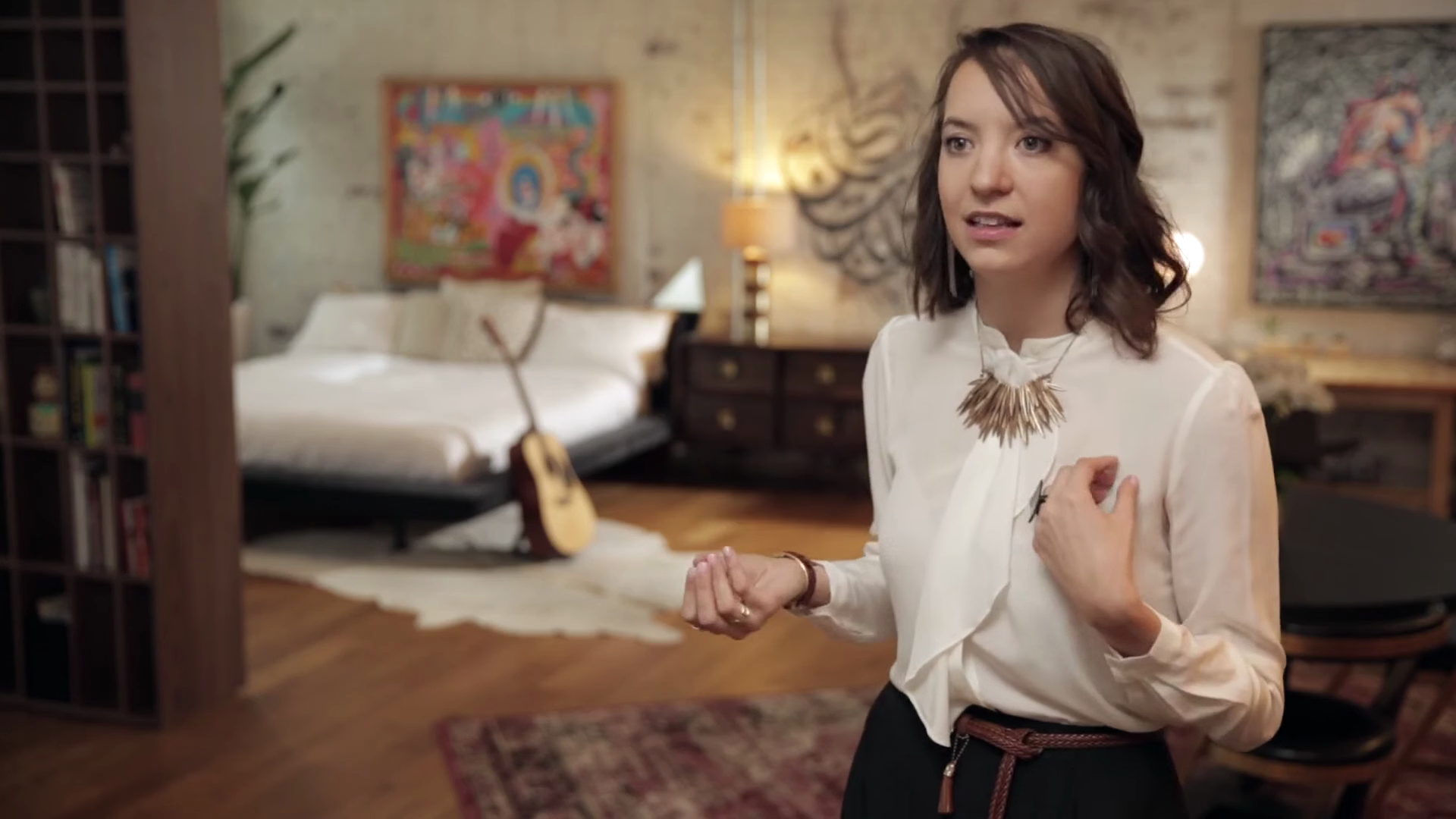 Joyce Elizabeth Tranchida discussing the studio interior, original unretouched video frame
