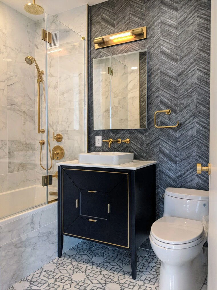 The Mondrian bathroom with dark chevron tile and brass details